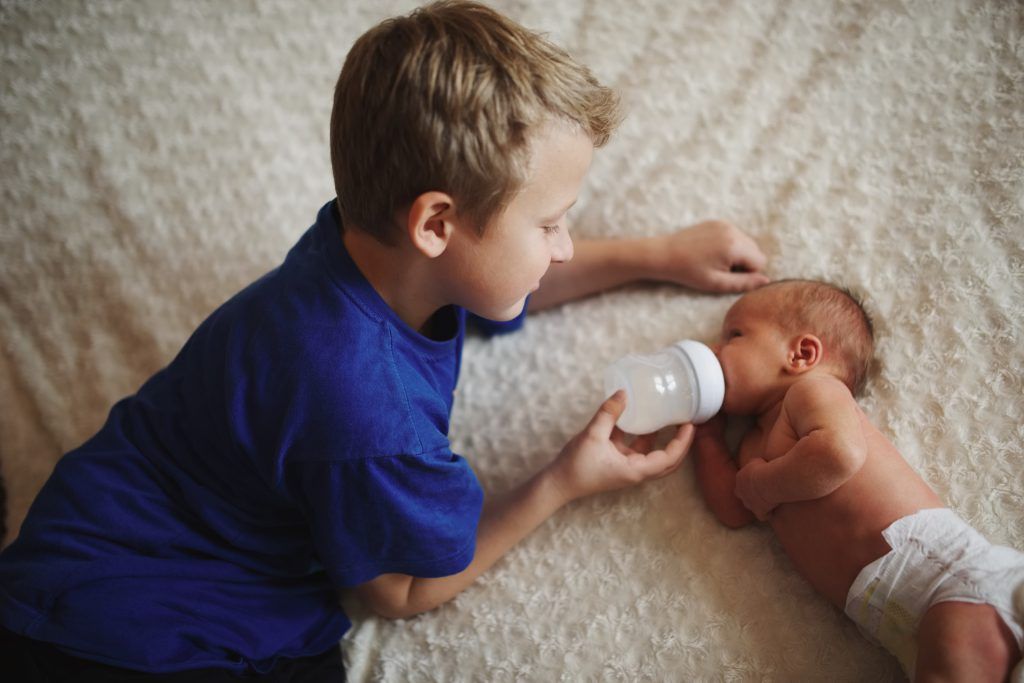 Feeding the newborn - new sister and brother