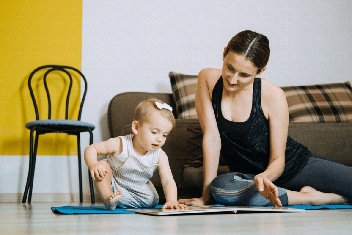 Learning Activities for Toddlers Baby. Mother reading book with cute Toddler baby daughter