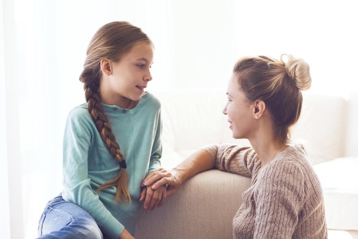 Mom with her pre-teen daughter hugging, positive feelings, good relations.