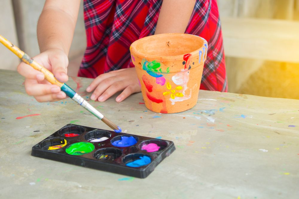 Asian little child for painting pot activity in holiday family