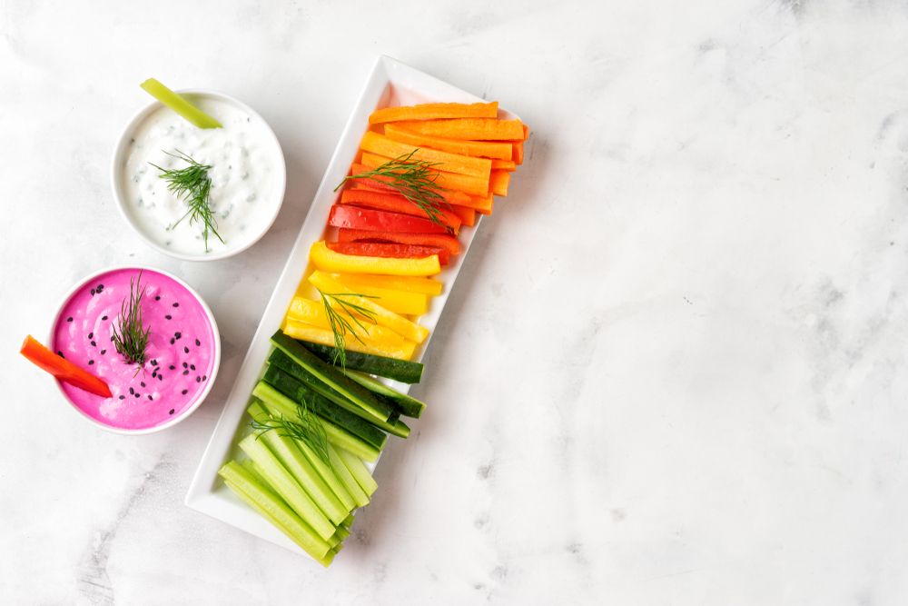 Colorful vegetable sticks with yogurt dips. Top view.