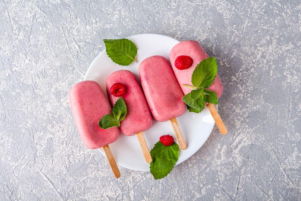 Step by step recipe. Cooking Homemade pink ice cream. Step 7 frozen natural fruit and berry popsicle sugar free on plate