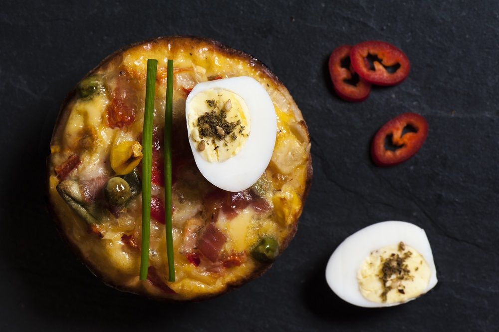 Veggie and bacon mini quiche with quail egg