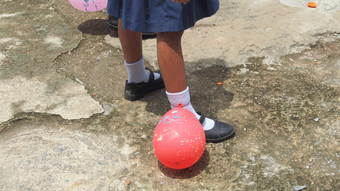 Asian elementary school children's games, balloon stomp. The balloons are tied at the ankle.