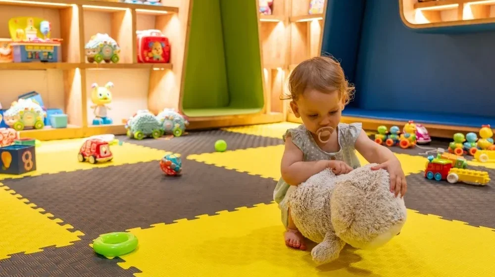 Childcare professional engaging with children, demonstrating essential qualities in a daycare setting.