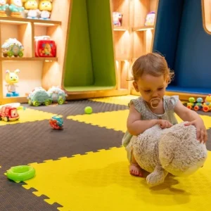 Childcare professional engaging with children, demonstrating essential qualities in a daycare setting.