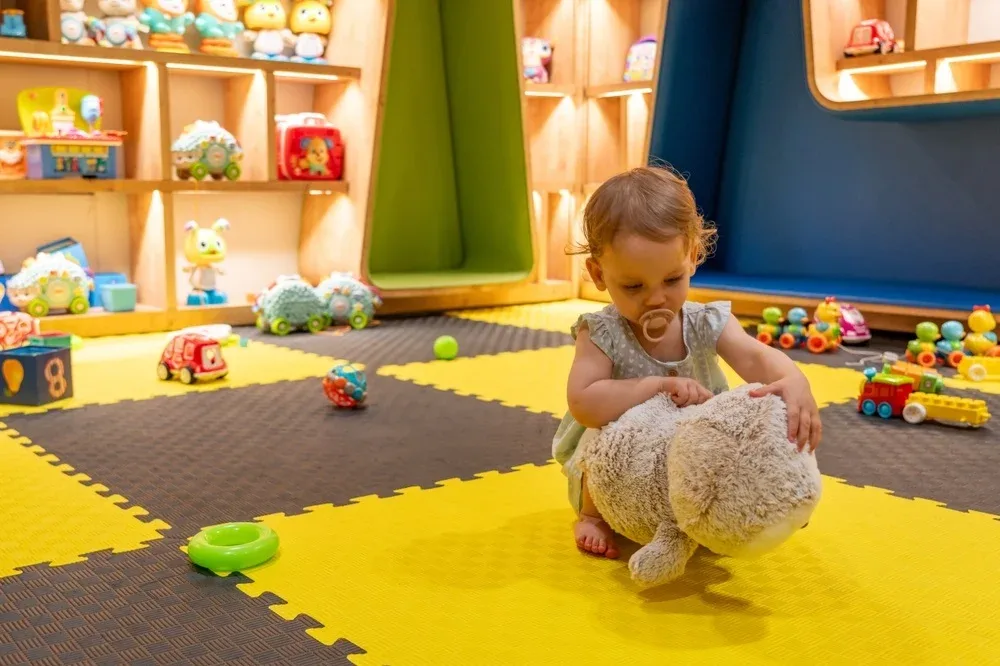 Childcare professional engaging with children, demonstrating essential qualities in a daycare setting.