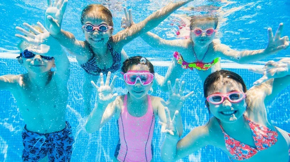 Children engaging in safe and fun water activities at DeeCyDa Daycare, splashing and playing in supervised outdoor water play areas.