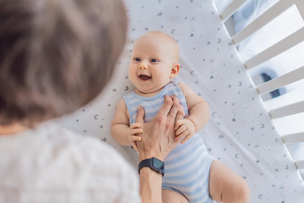 Daycare for Infant: What Irvine Parents Should Know Before They Trust a Childcare Center 4 caregiver supporting baby at childcare center in Irvine
